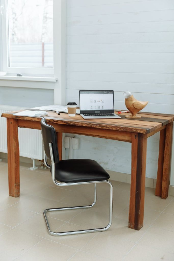 computer on a wooden desk with the designer s business website on the screen