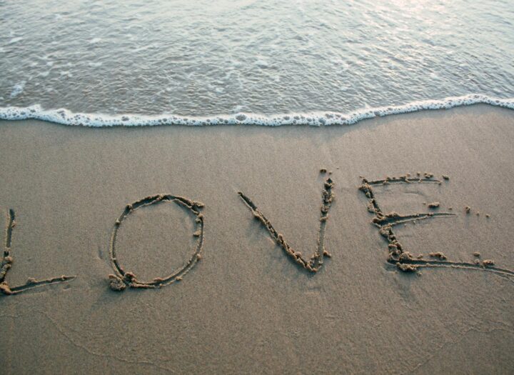 brown sand love text on seashore